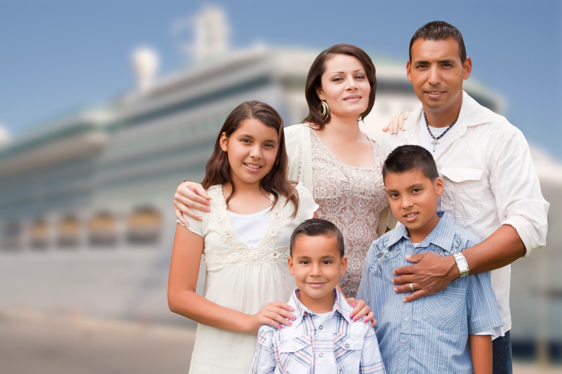 Young Happy Hispanic Family In Front of Cruise Ship